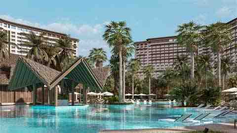 Tropical resort pool with swim-up bar, surrounded by palms and hotels.