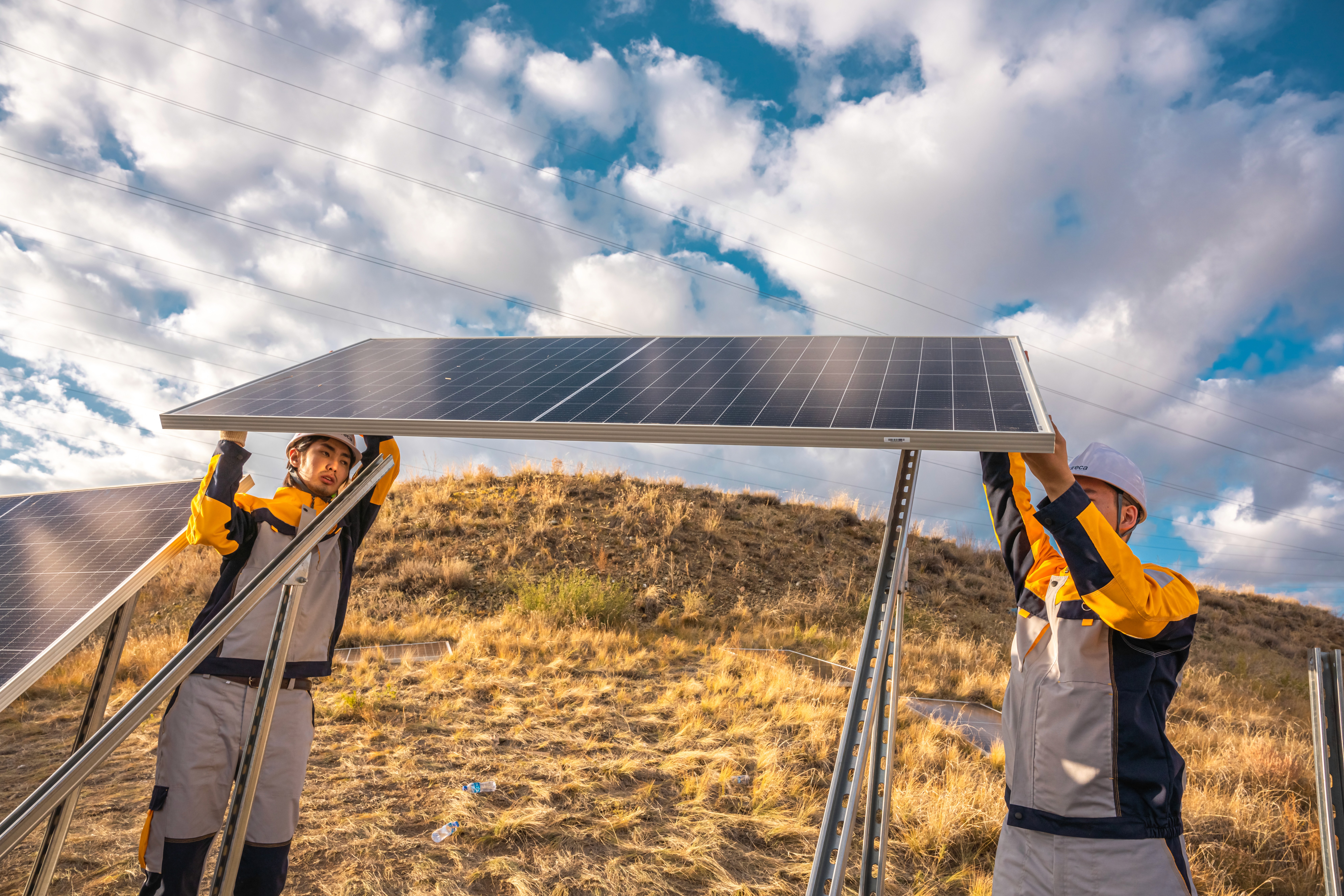URECA engineers installing solar panels on a hillside
