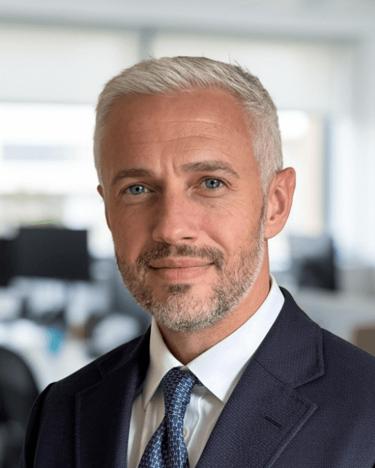 Man in suit with arms crossed smiling