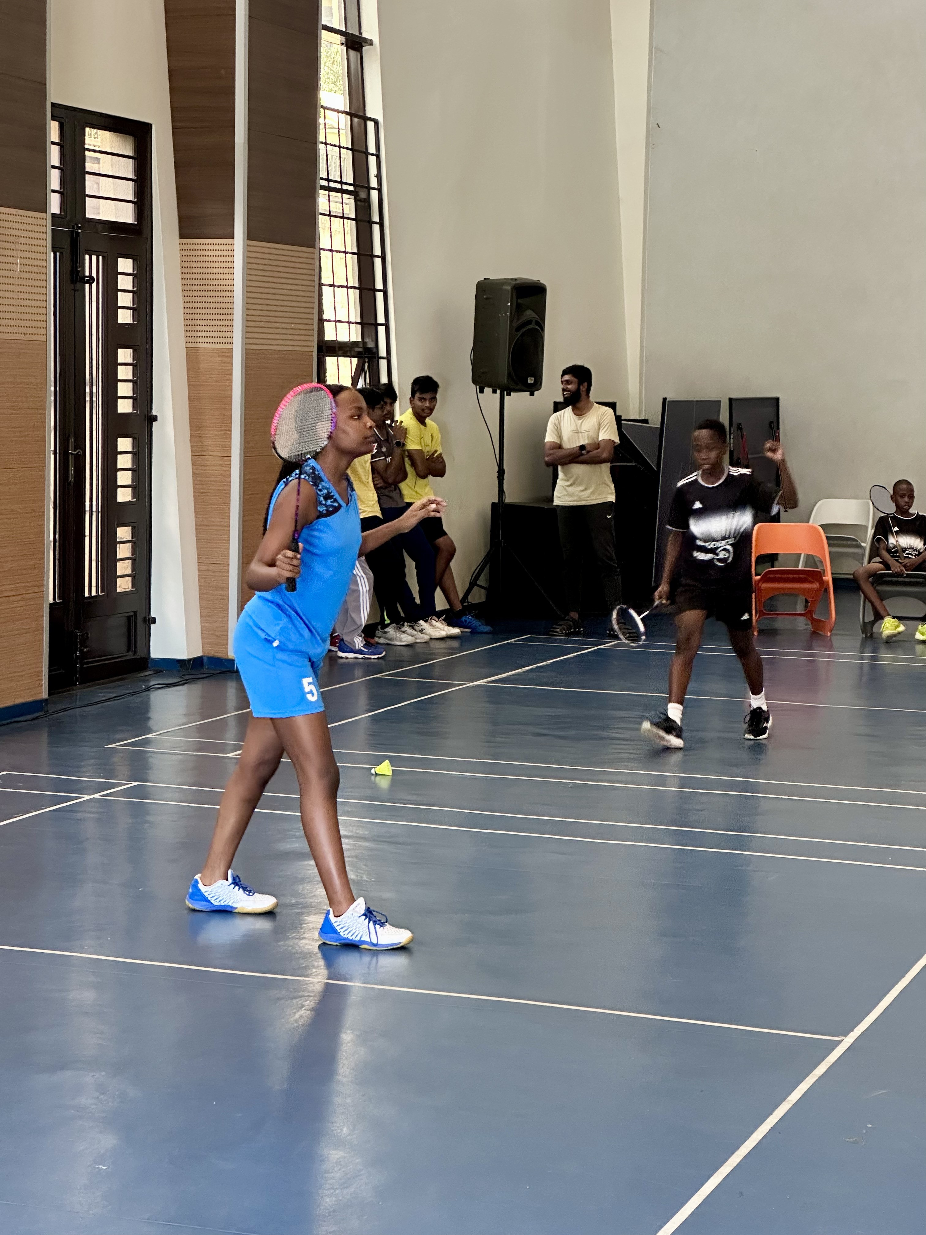 A student stands with a backpack on, ready for school