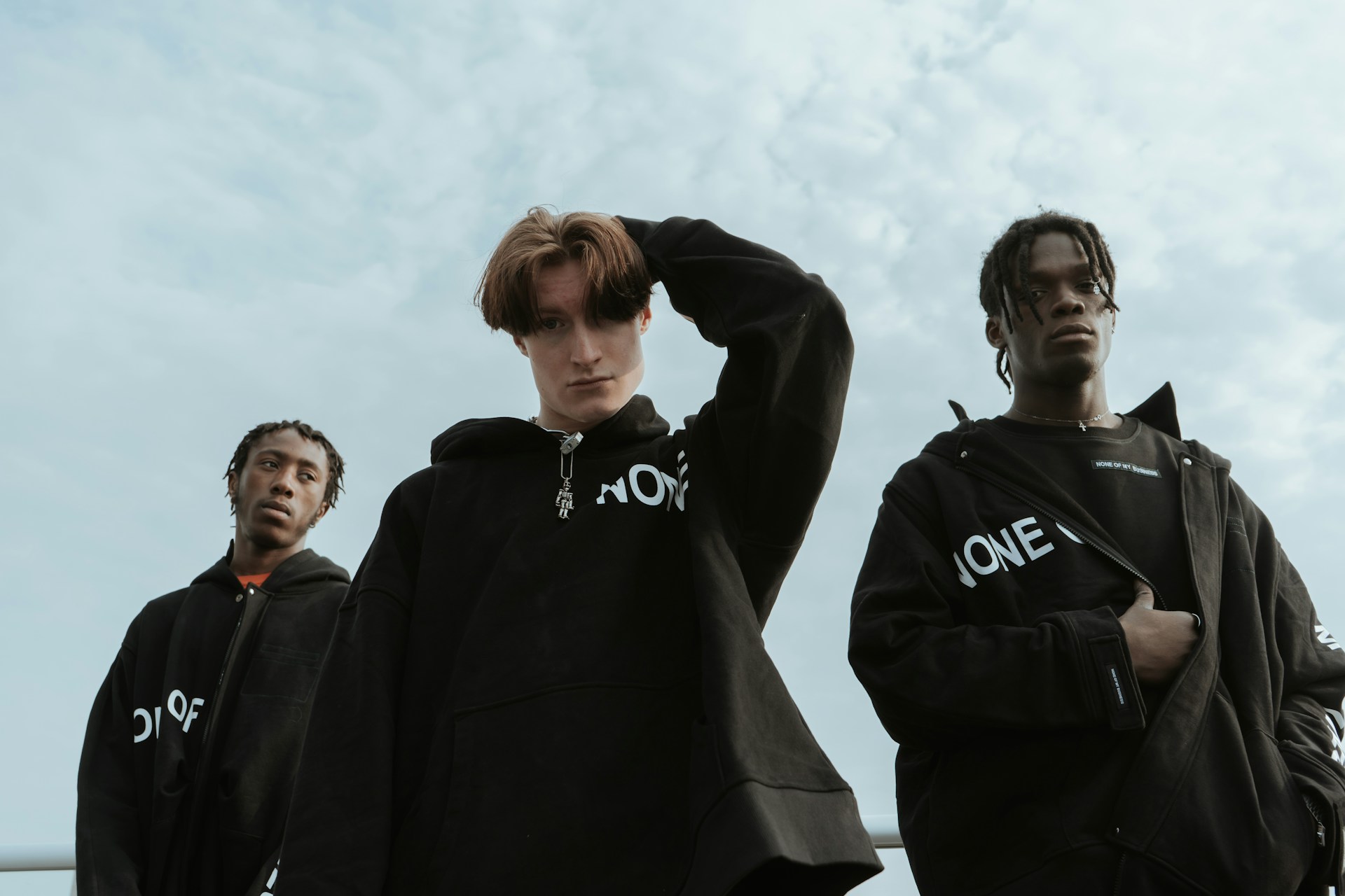 Creative shot of 3 models wearing similar black jacket from ordinary