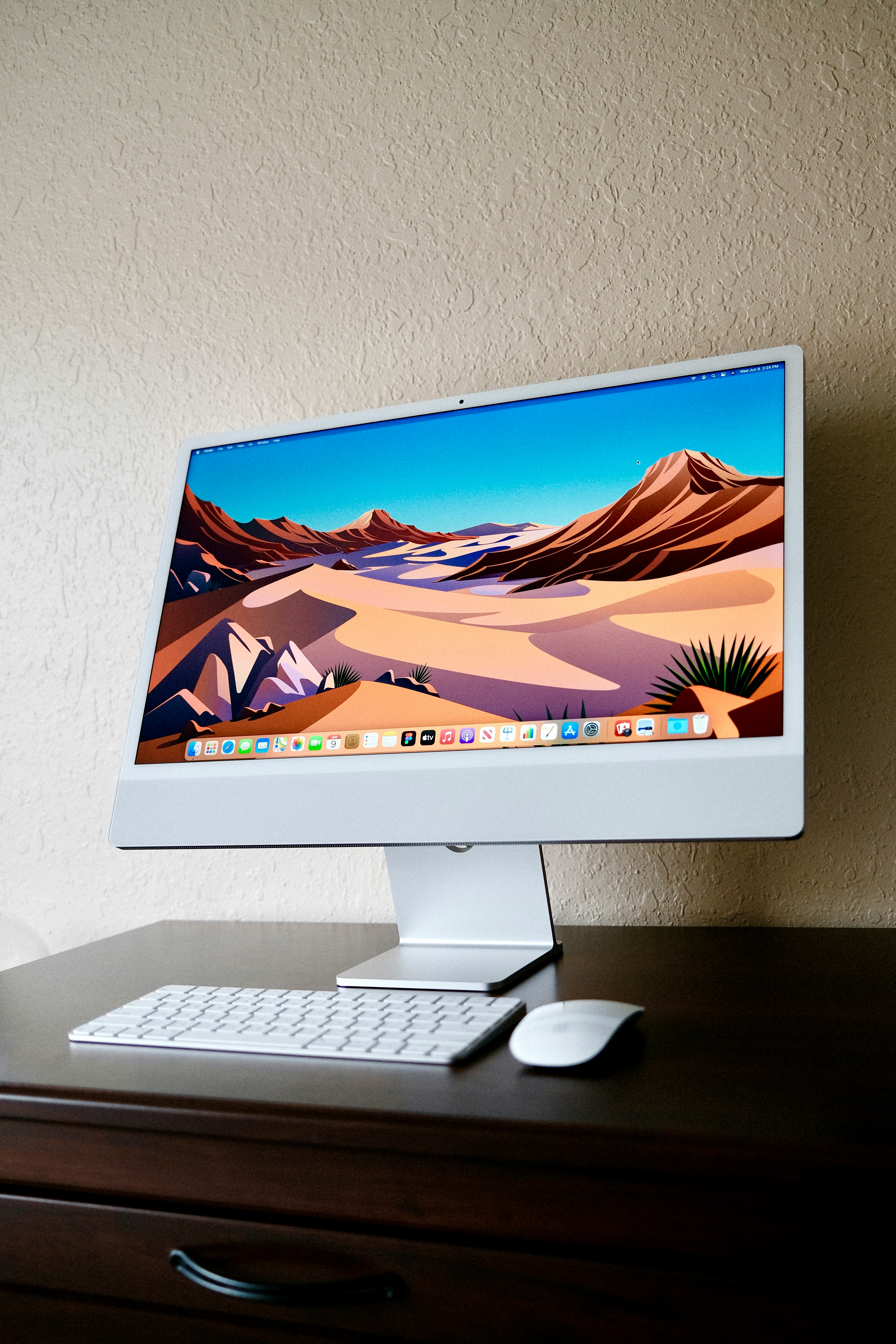 a desktop computer sitting on top of a wooden desk