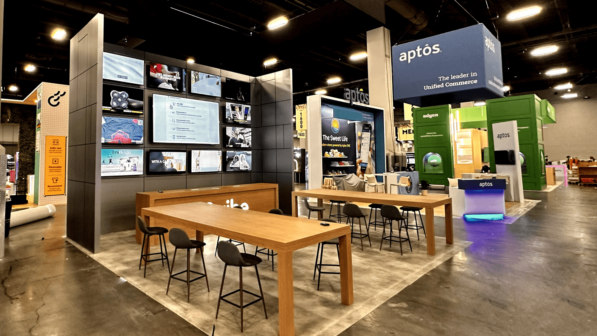 20x20 retail product display booth rental layout with branded graphics, product presentation area, and meeting space at Shoptalk