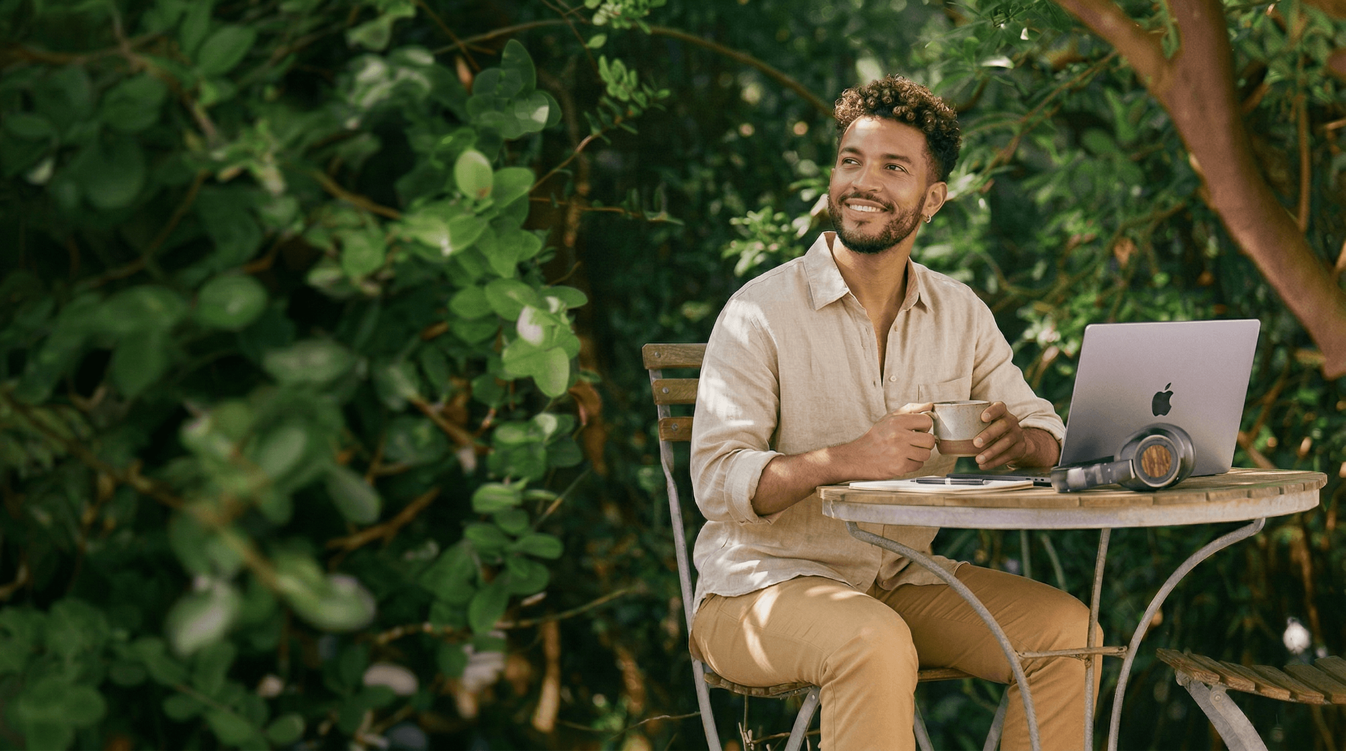 Professional working on laptop outdoors representing AI powered team extension and scalable content production