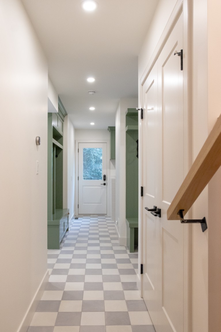 Image of Luxurious home interior with green accents, checkered floor, and modern design by KHD Homes builder.