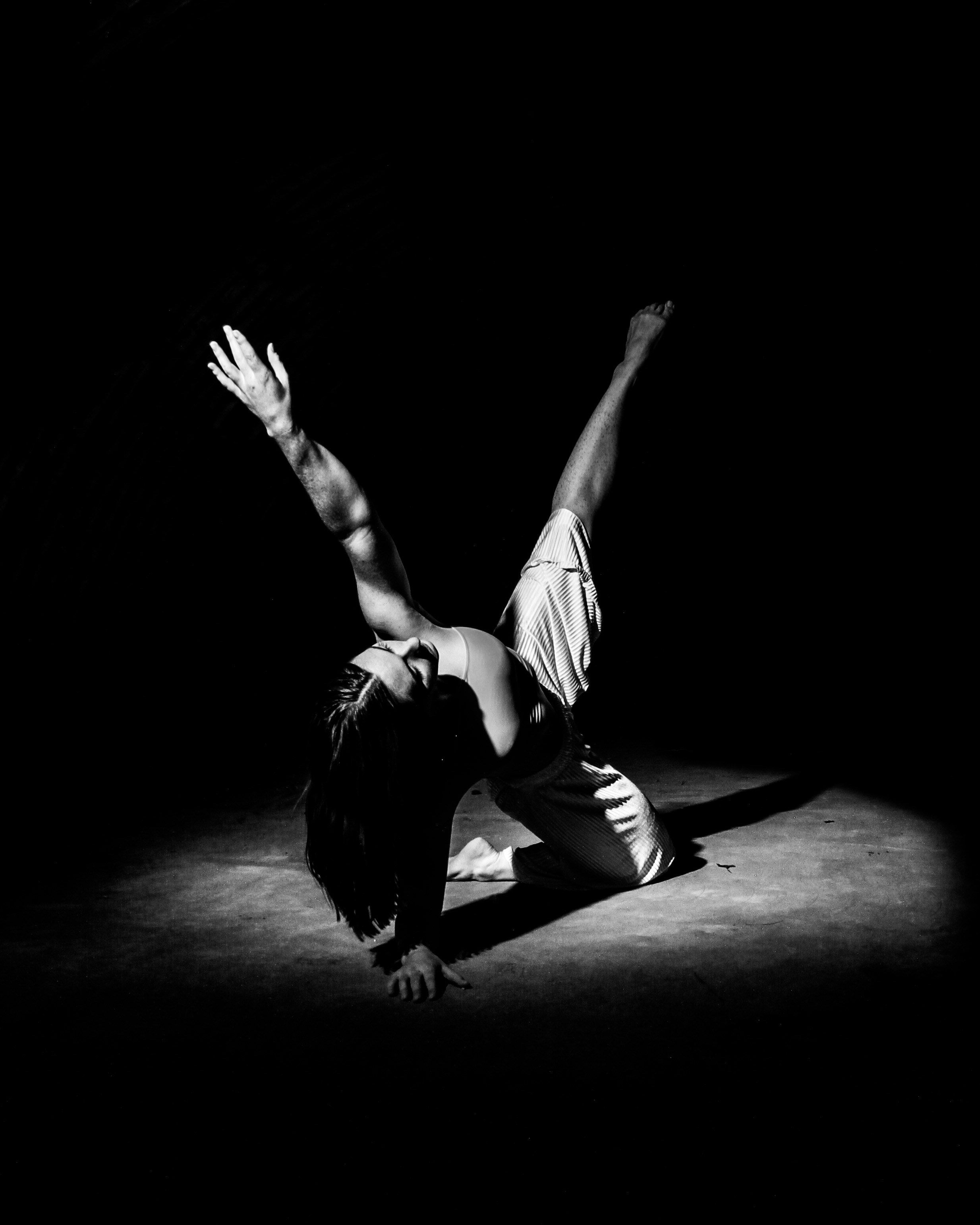 a black and white photo of a woman with a tattoo on her arm