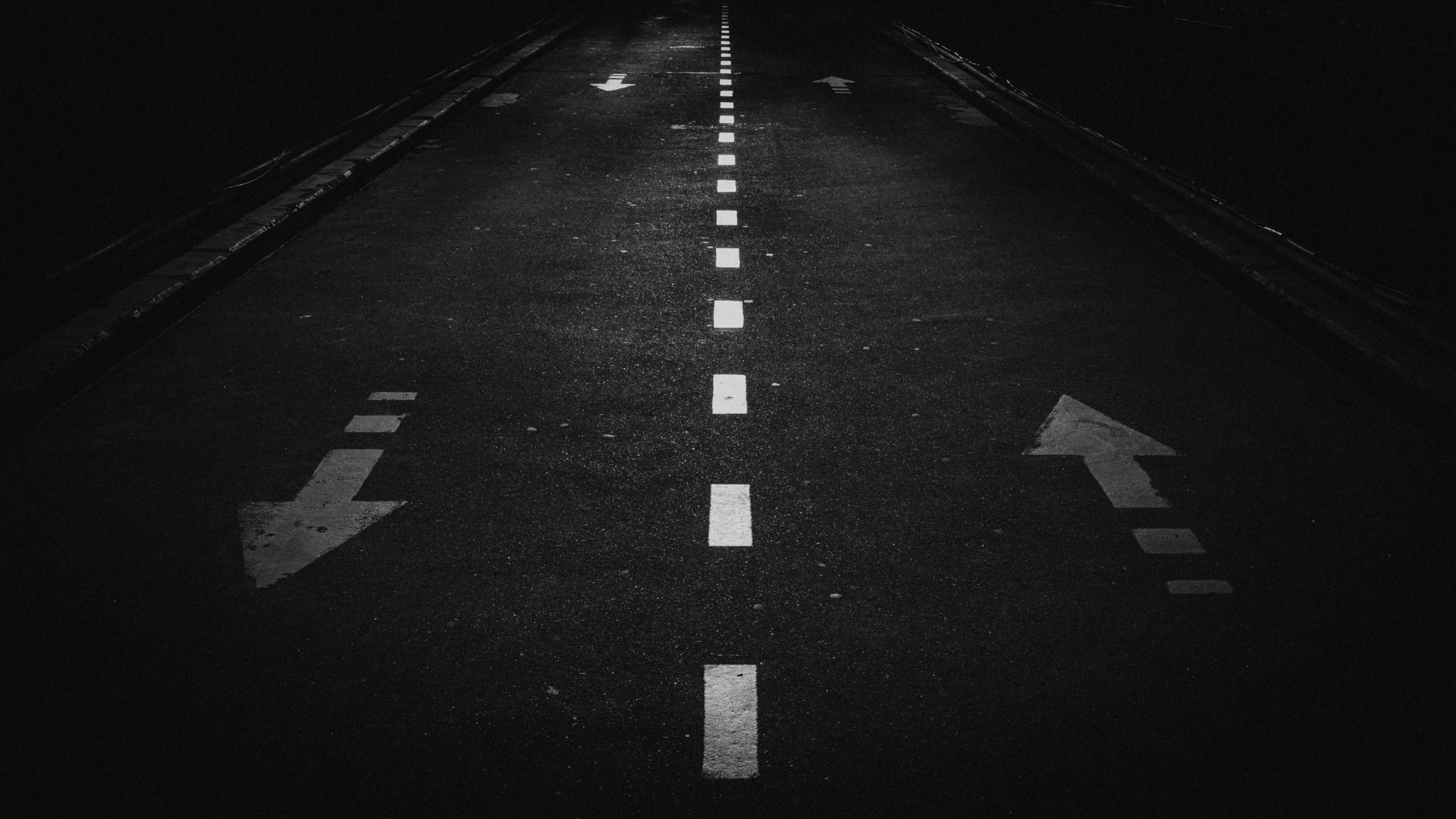a road with white arrows