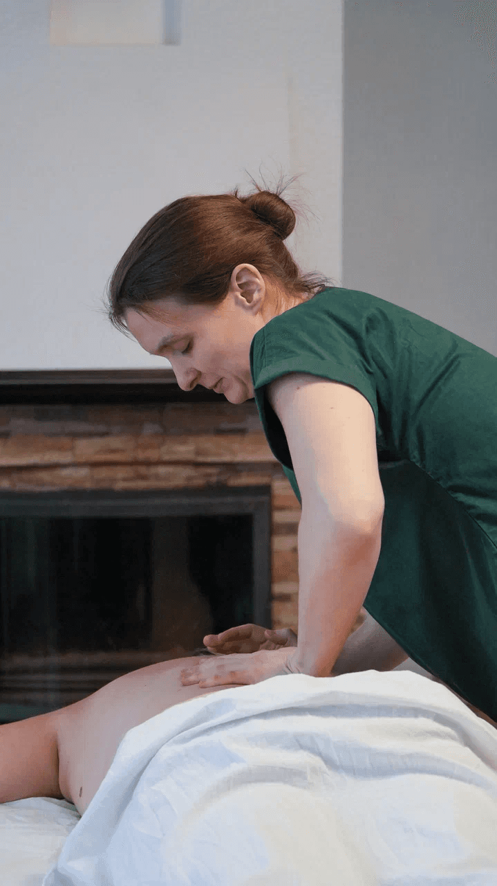 Massage therapist giving a back massage.