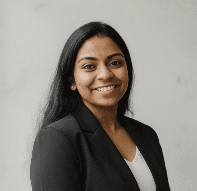 Portrait of a person in dark clothing speaking on a phone