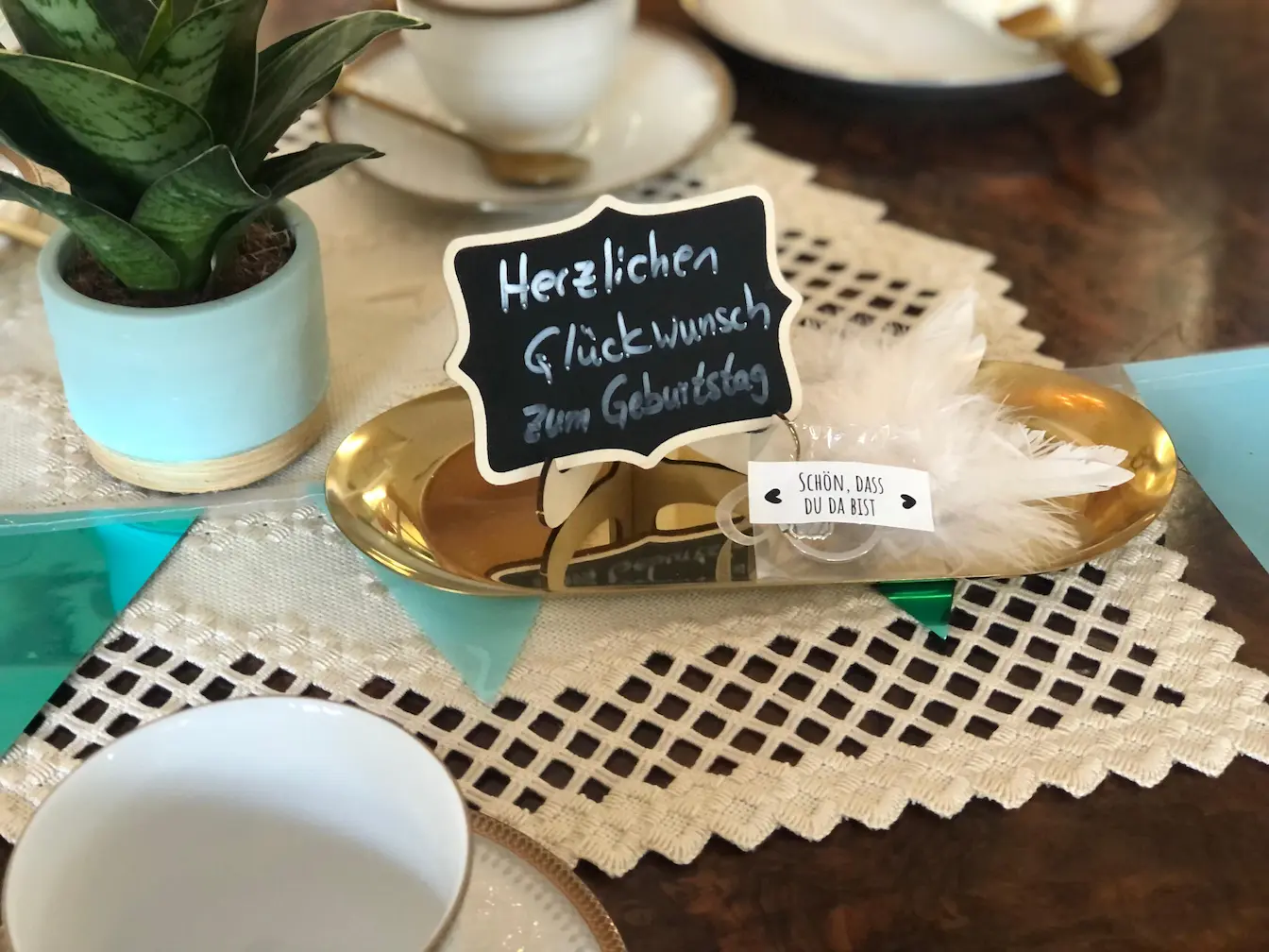 Ein gedeckter tisch wo eine Karte zum Geburstag graturliert