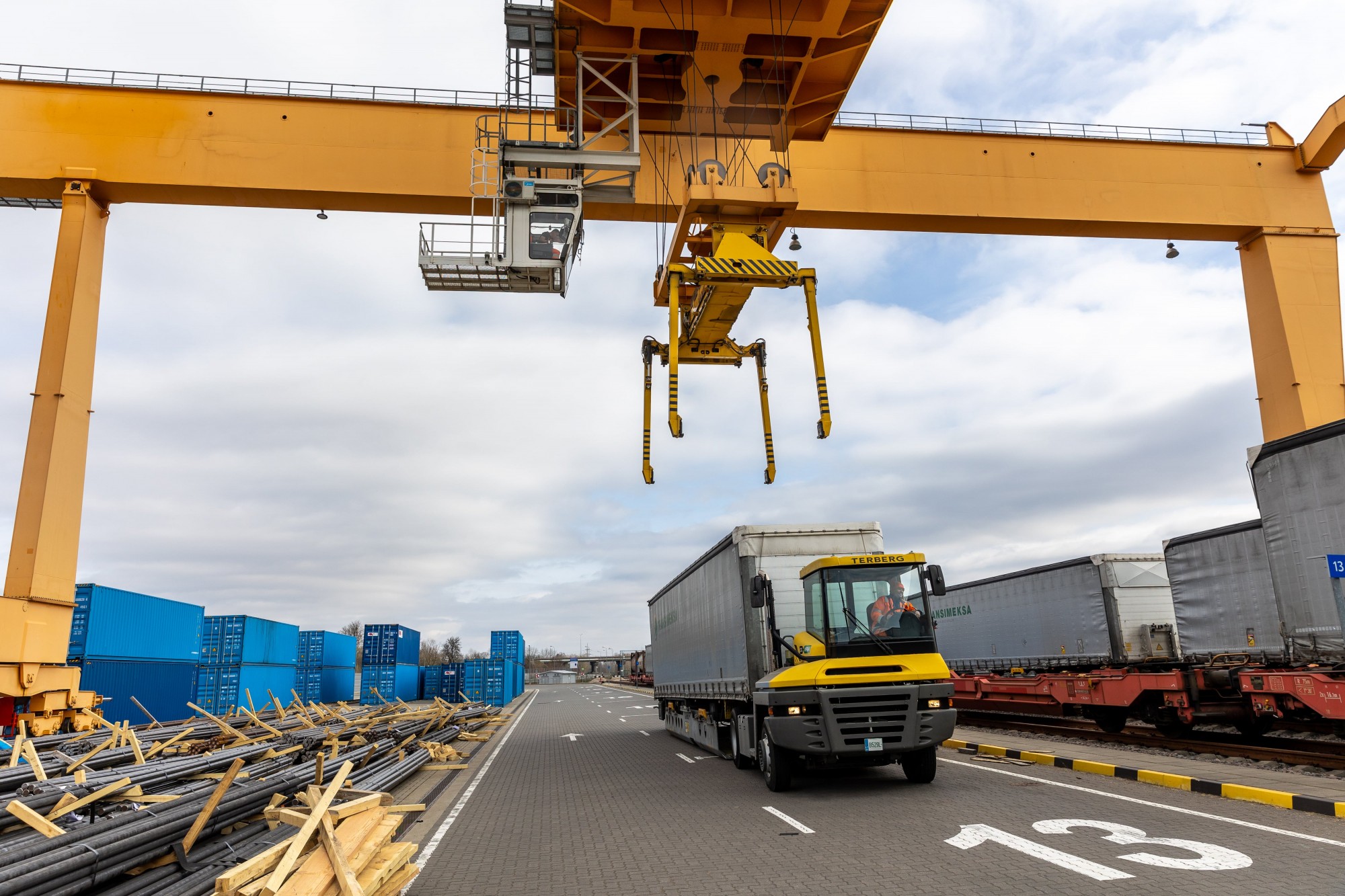 Intermodal freight terminal in Poland with trucks, cranes, and railcars demonstrating seamless transport integration.  