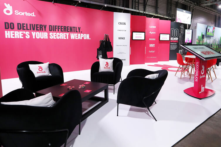 Sorted exhibition stand with branding and seating area