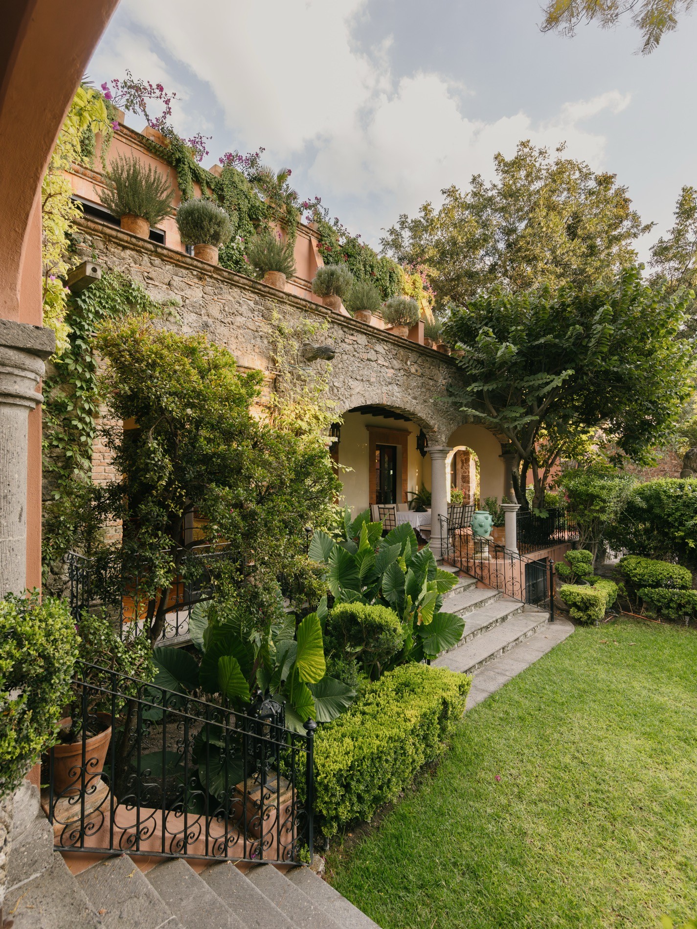 La Residencia San Miguel terraces and garden levels with climbing vines and outdoor dining below
