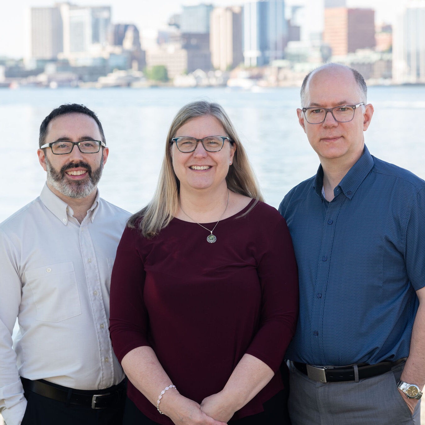 brown and white long coated small dog wearing eyeglasses on black laptop computer