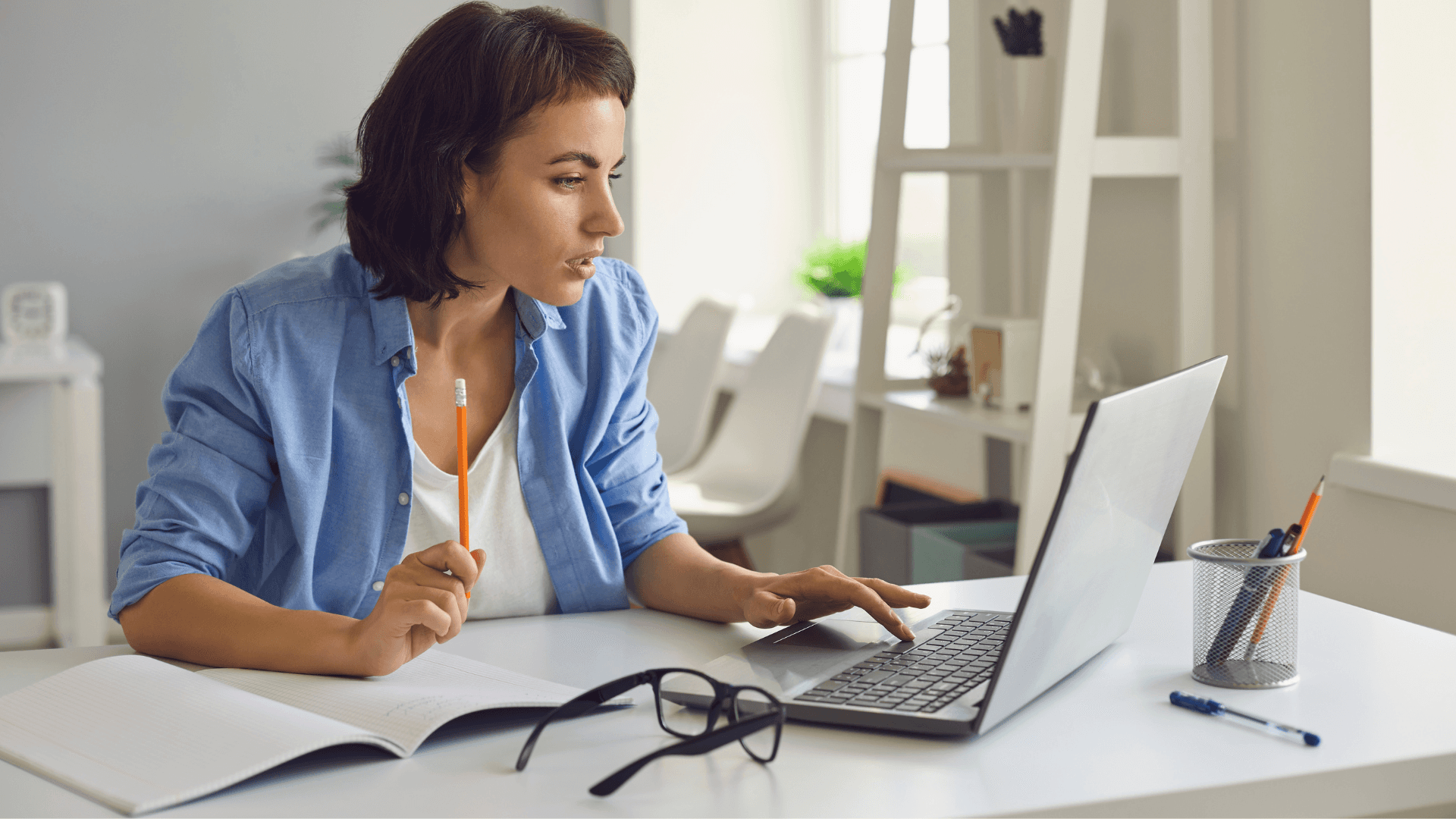A woman smiling while working at a computer