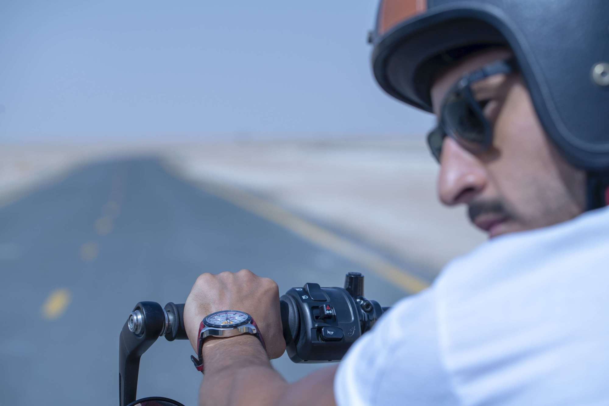 Male model on a motorbike showcasing Baume & Mercier watch: Baume & Mercier Campaign Photoshoot | Relity Group
