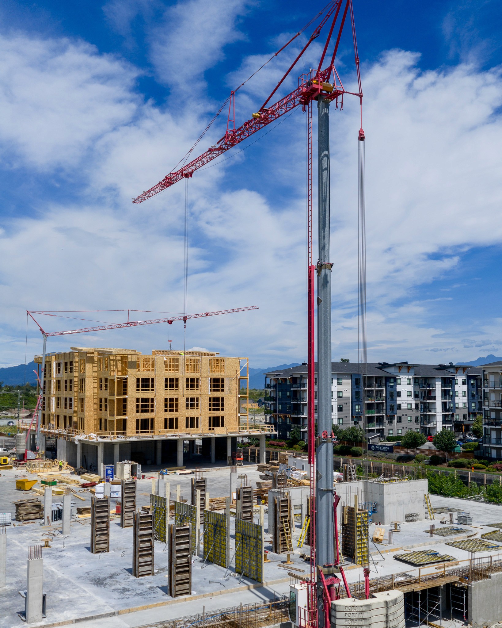 Construction site in Chilliwack, Fraser Valley, British Columbia, with cranes and buildings under development.
