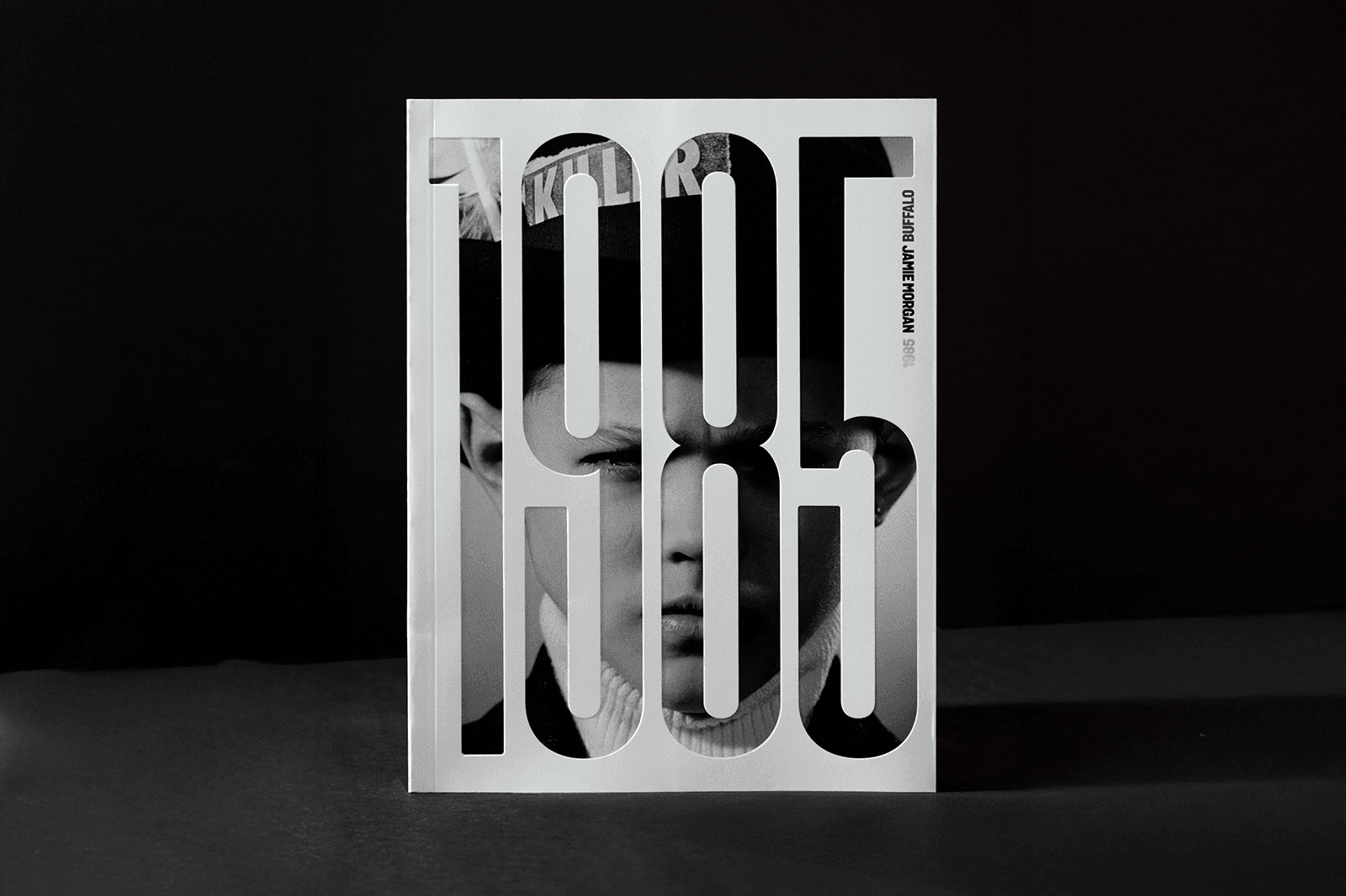 A stylized image featuring the number "1985" in bold, abstract typography against a dark background.