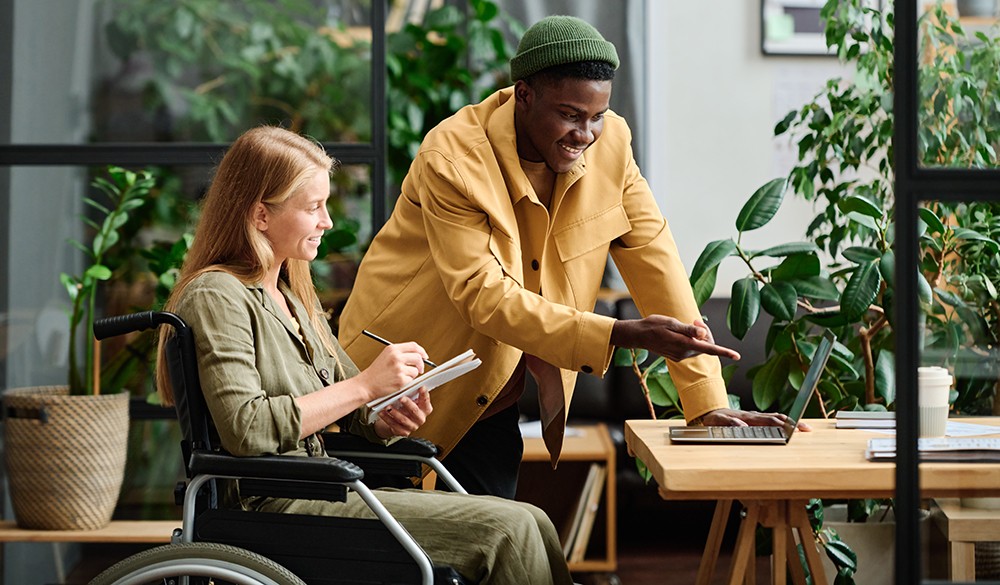 Two colleagues working together. One uses a wheelchair