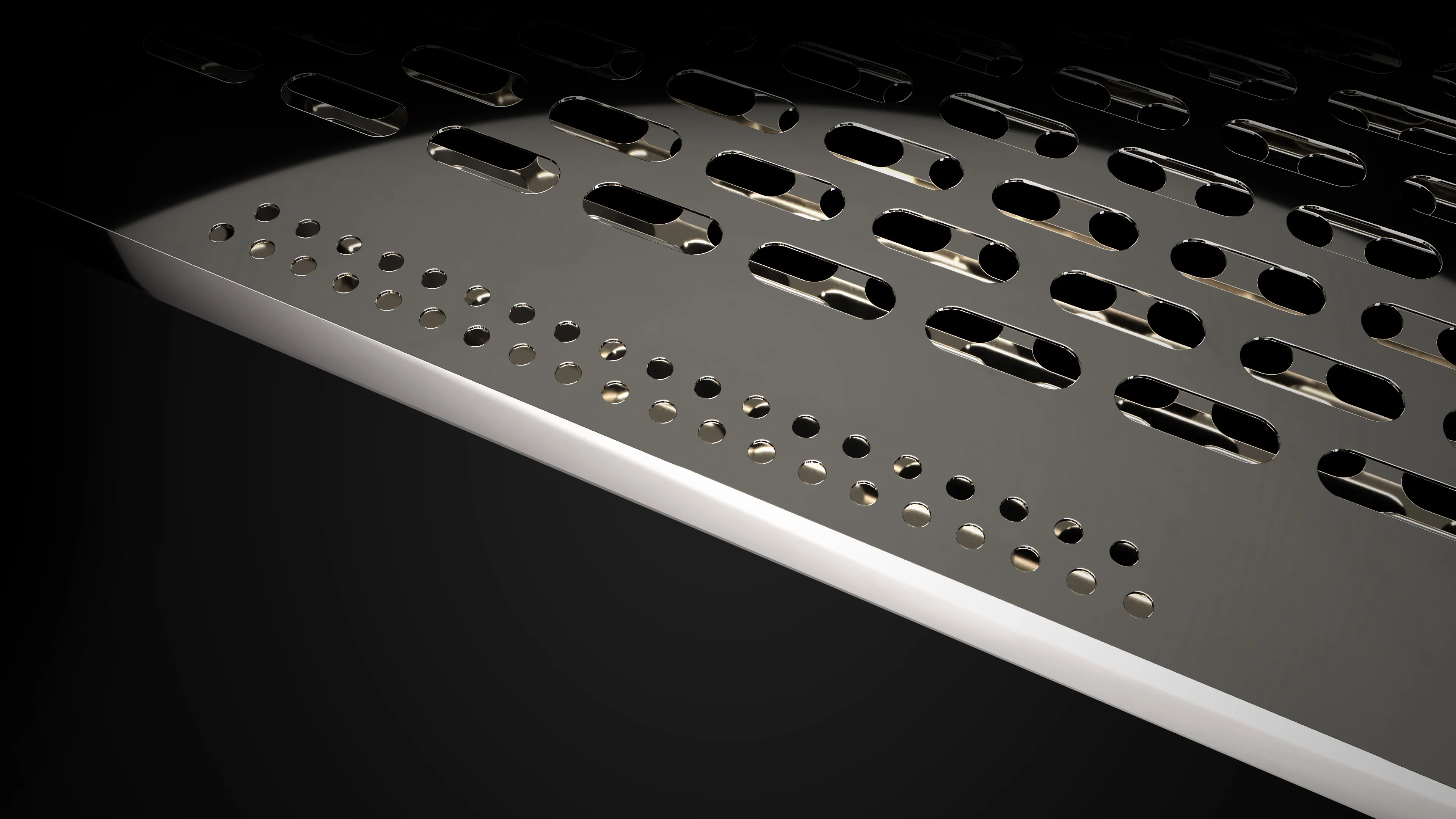 Close-up view of the metallic conveyor suction plate featuring slotted and circular holes. As part of the triple suction system, it provides extra hold to prevent film displacement and ensure consistent quality at high speeds.