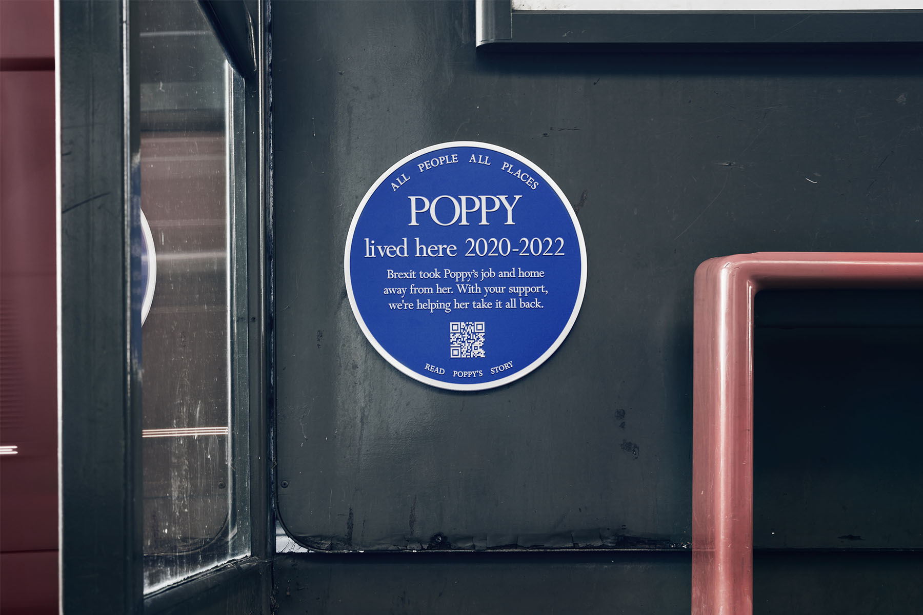 Blue plaque attached to the inside of a bus stop that say's Poppy lived here in 2020 - 2022