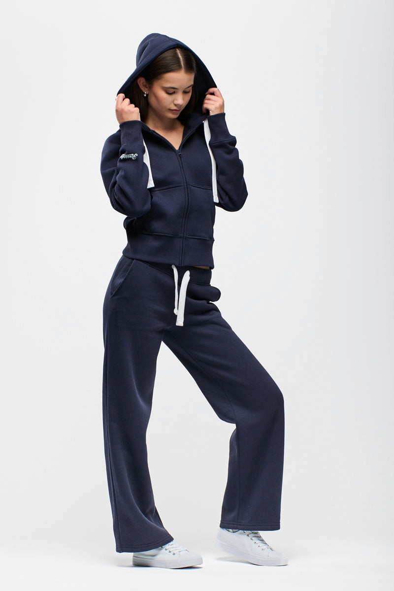 Person wearing a navy tracksuit with a hood on a white background