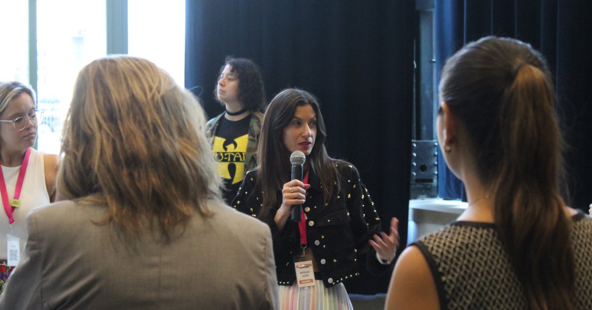 A speaker holding a microphone