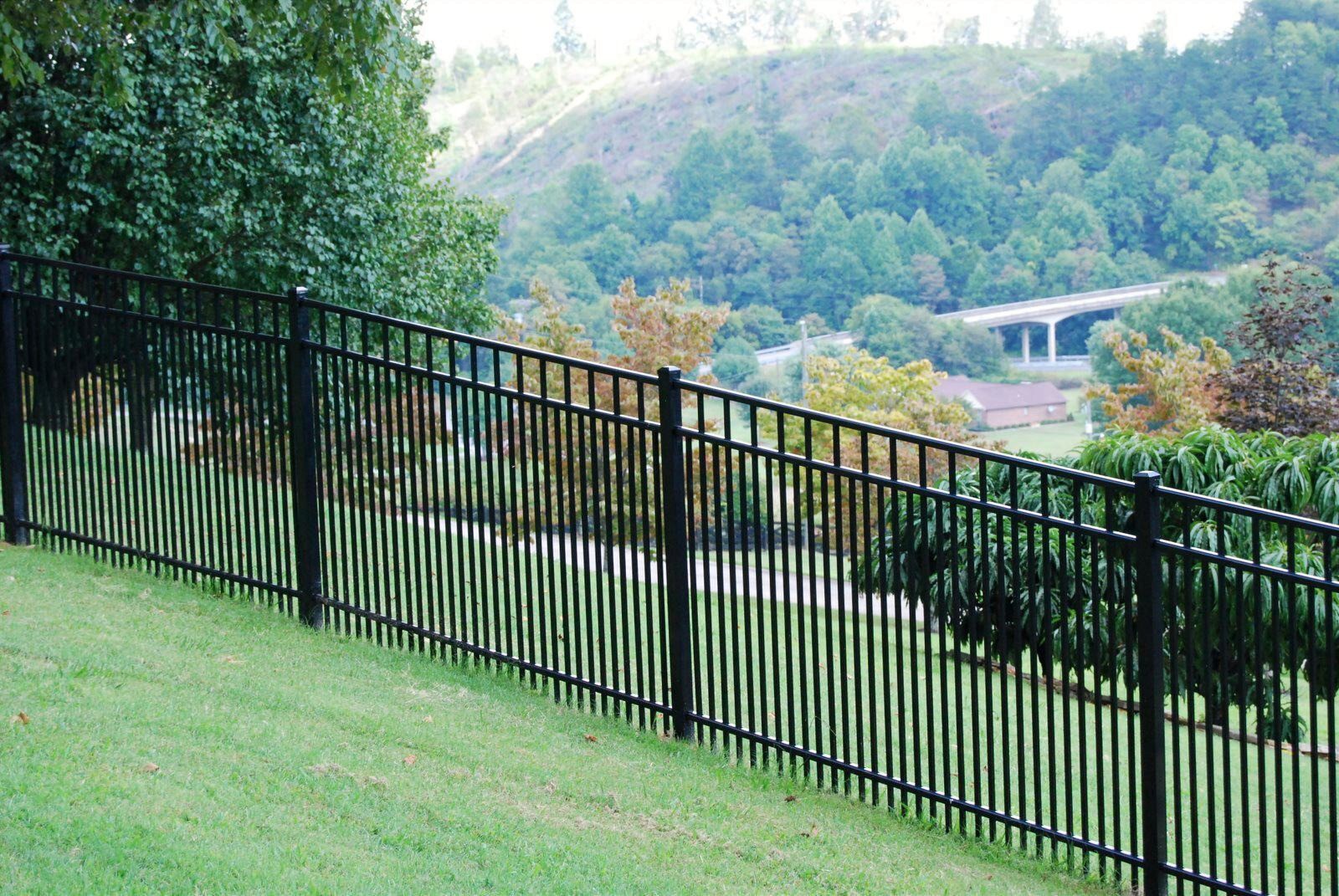 Black Grandview Horizon Pro aluminum fence installed on a slope with rolling hlls in the background