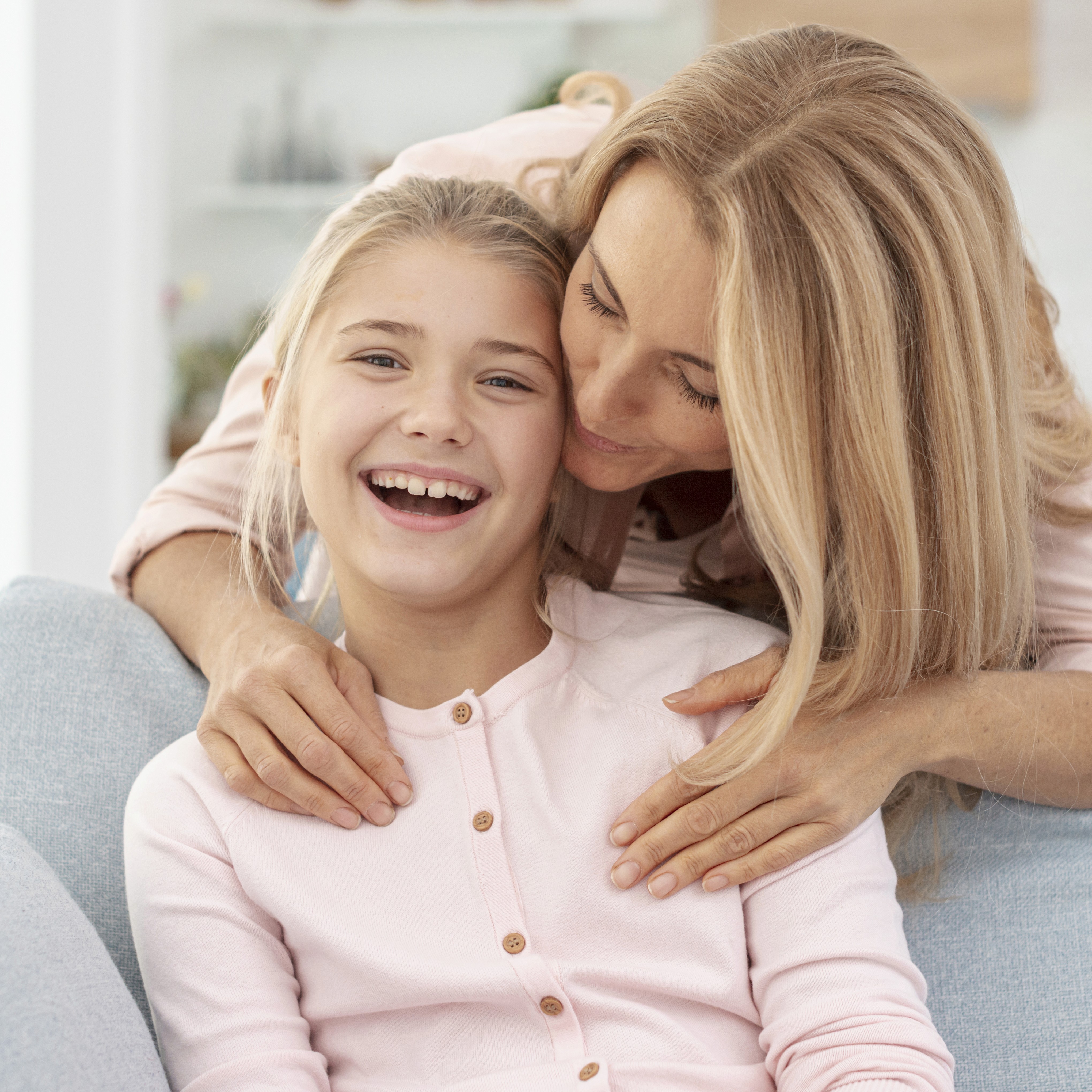 Woman behind young smiling girl
