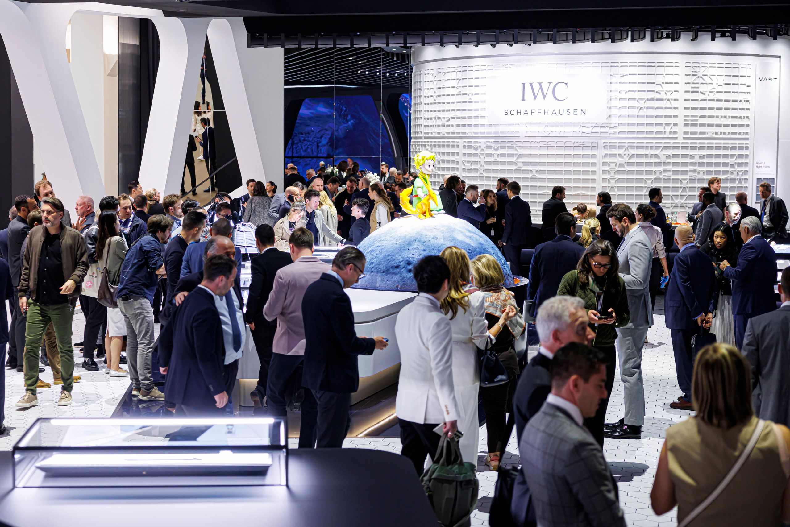 IWC Schaffhausen booth with Little Prince installation and crowd exploring exhibition space
