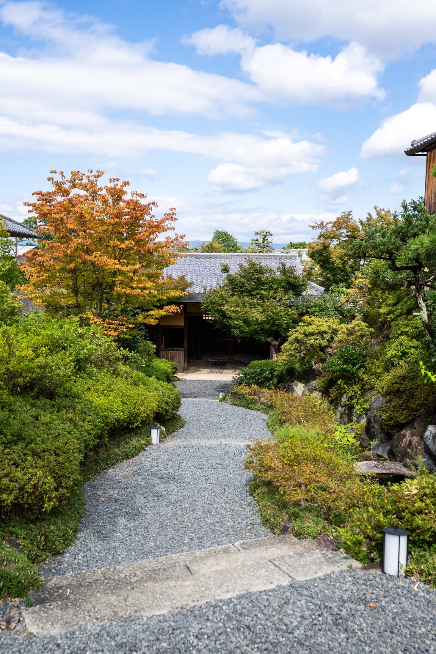 Gravel garden path winding past clipped pines and maples at Park Hyatt Kyoto