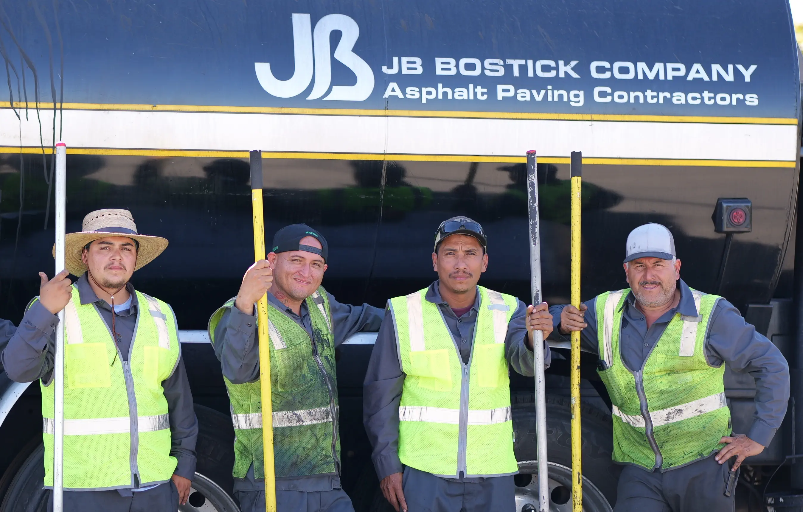 Construction crew with tools next to dumptruck