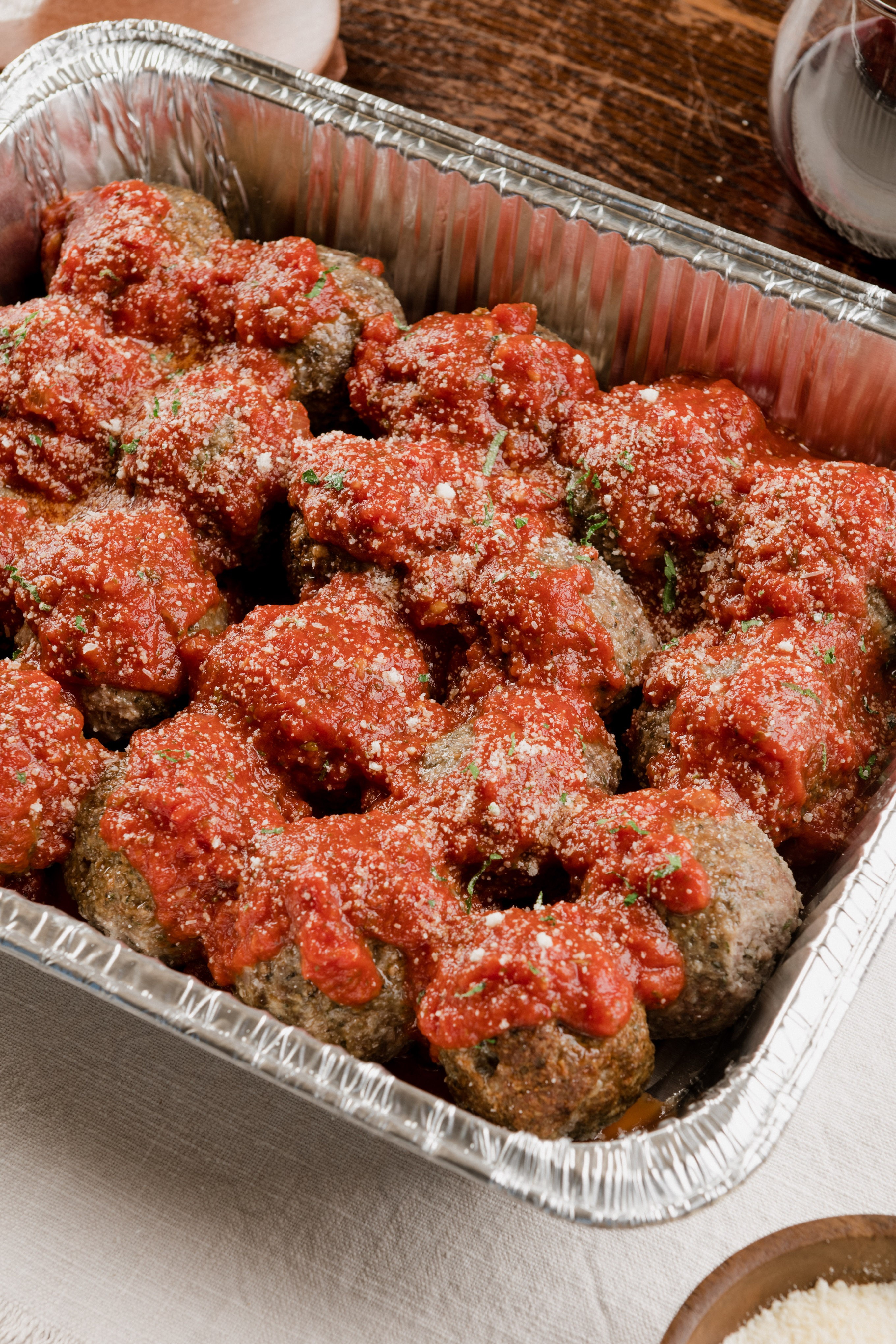 A man holding a cocktail in a dimly lit bar