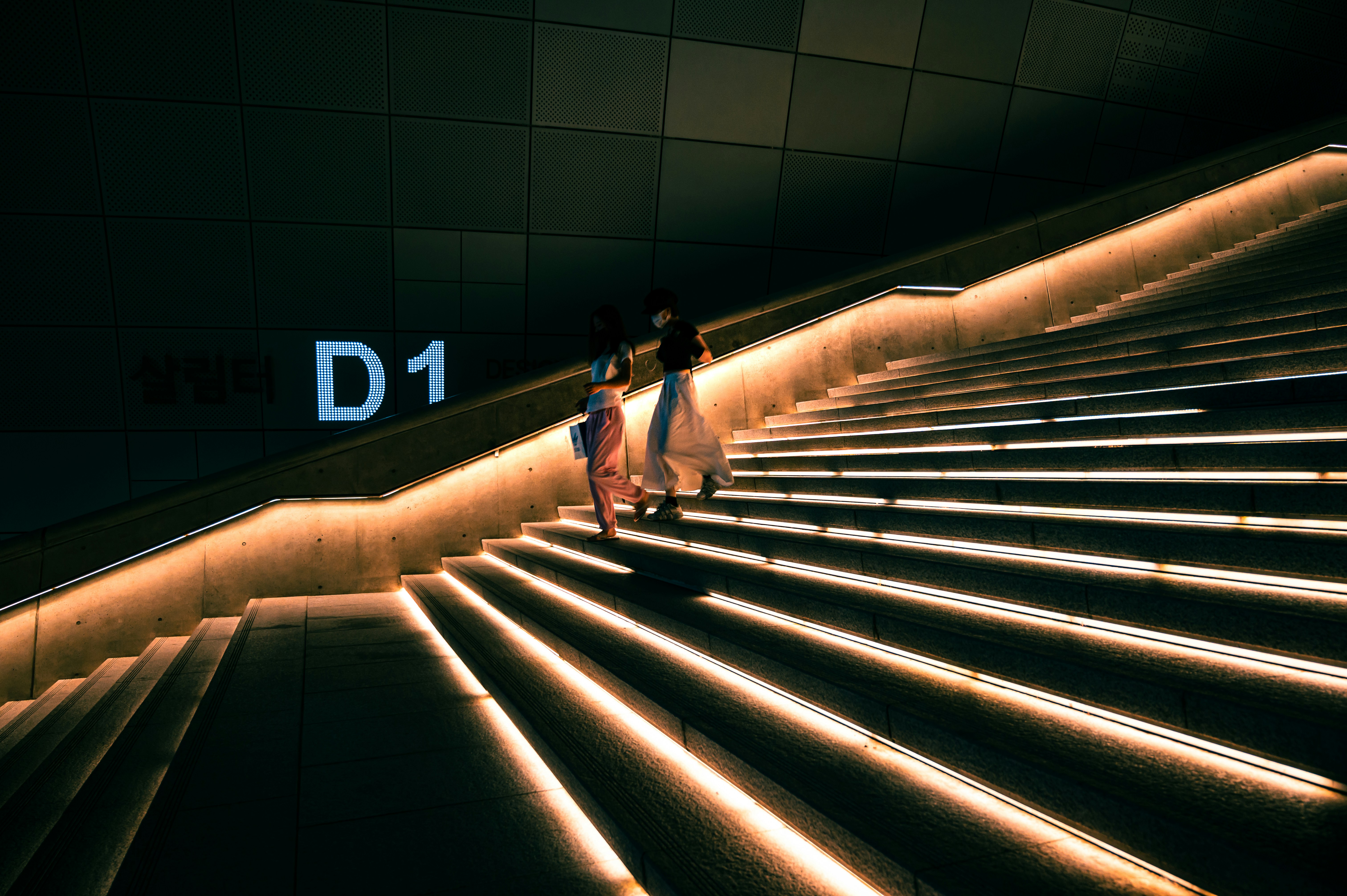 a couple of people that are walking down a set of stairs