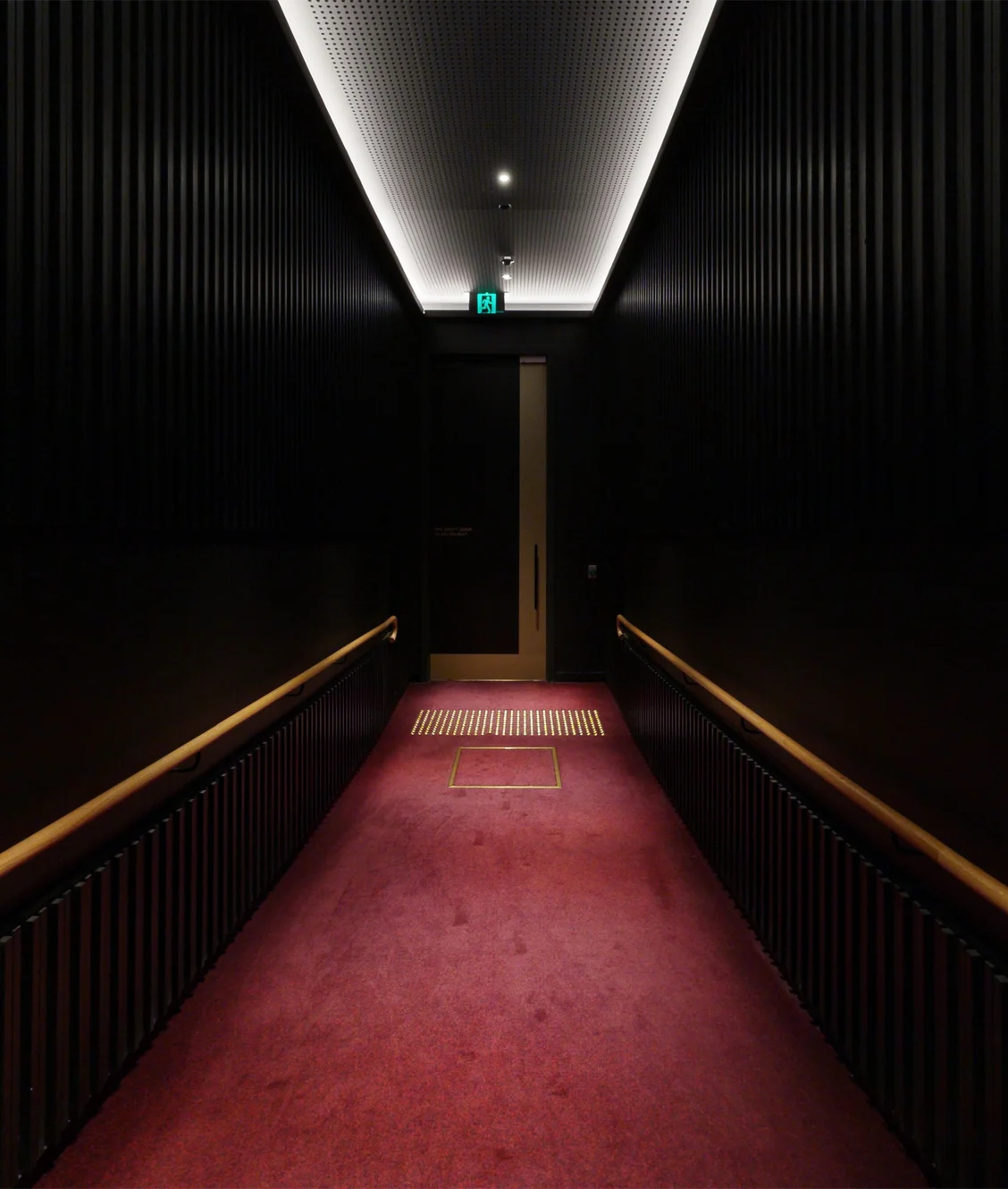 A high-fidelity 3D digital twin perspective of a tactile-paved corridor inside Her Majesty's Theatre, captured by ABM visual to highlight universal accessibility and enterprise-grade wayfinding capabilities.