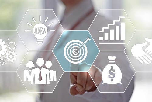 Business professional interacting with digital strategy icons representing goals, growth, and data-driven decision making.