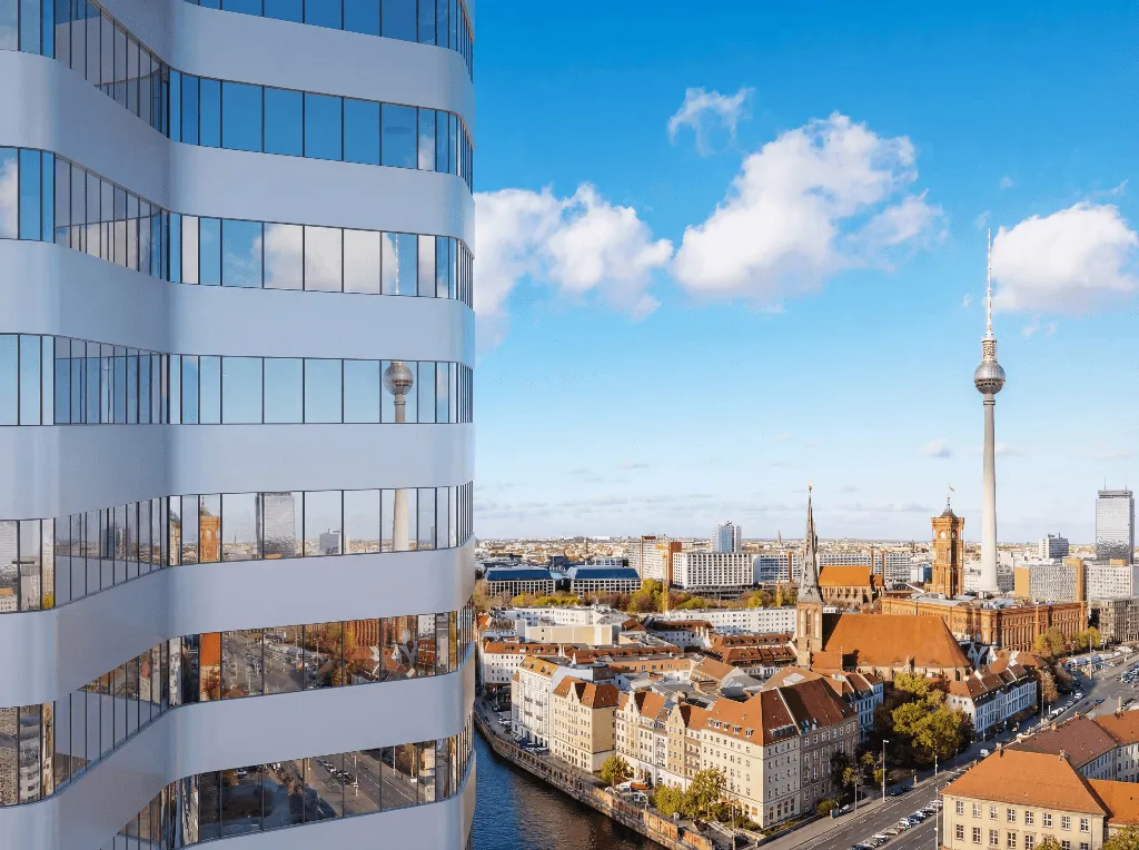 Modern cityscape with tall buildings and a river.