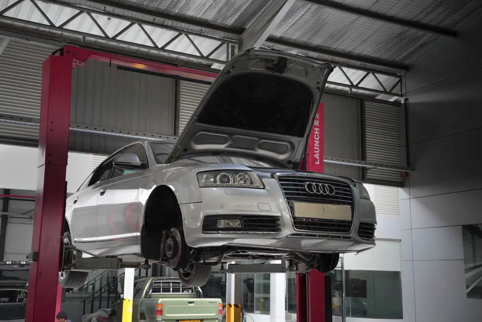 Mechanic repairing the accident marks of a car