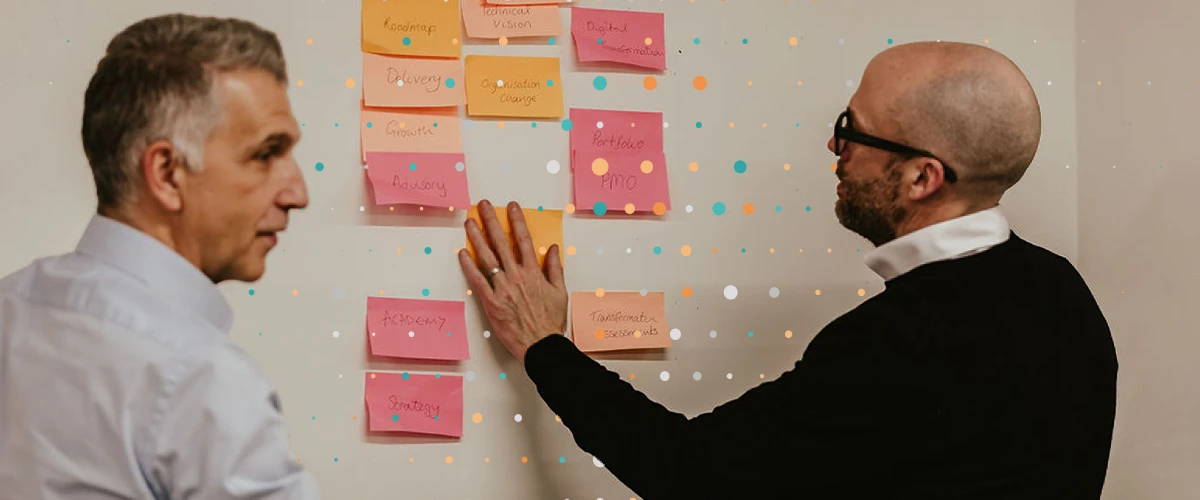 two people meeting with sticky notes