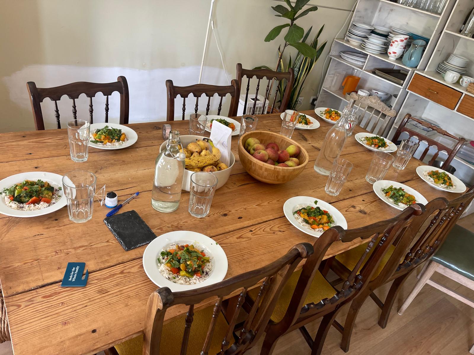 Photo of rustic dinner table set with a full meal for digital nomads moving to portugal