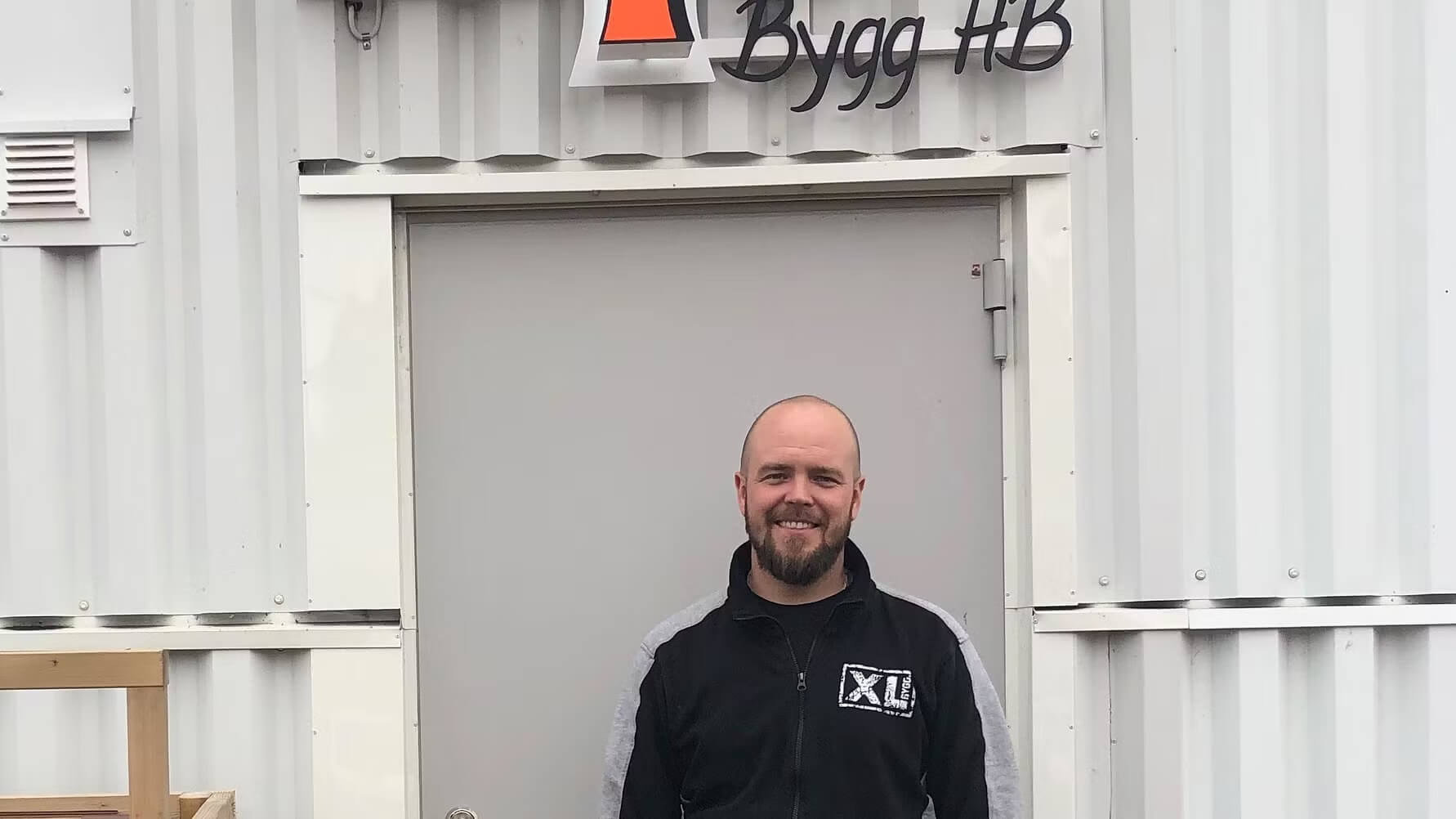 Close-up of lush, dark green leaves, some glossy and wet, against a muted background.