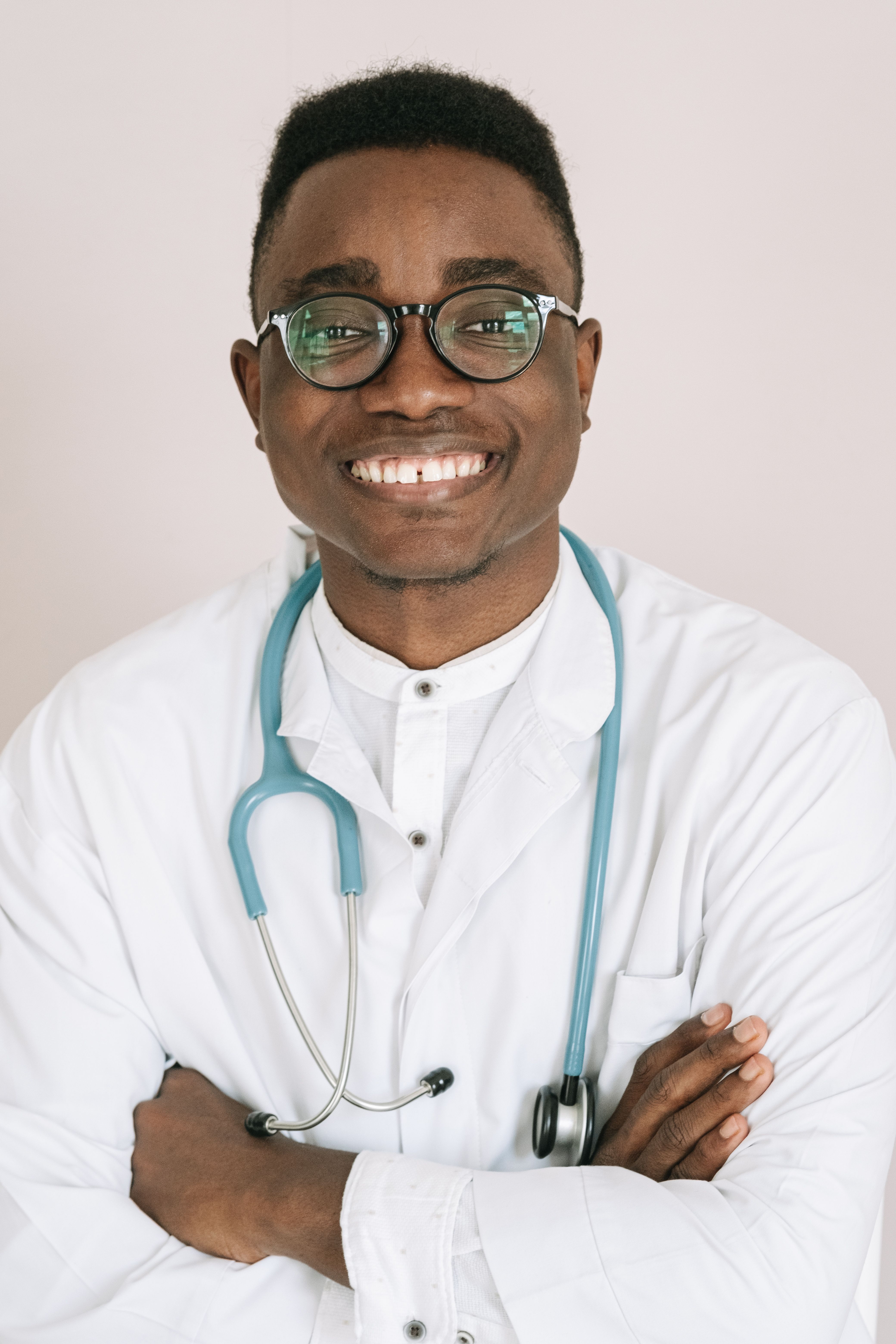 A man in a green scrub suit holding a toothbrush