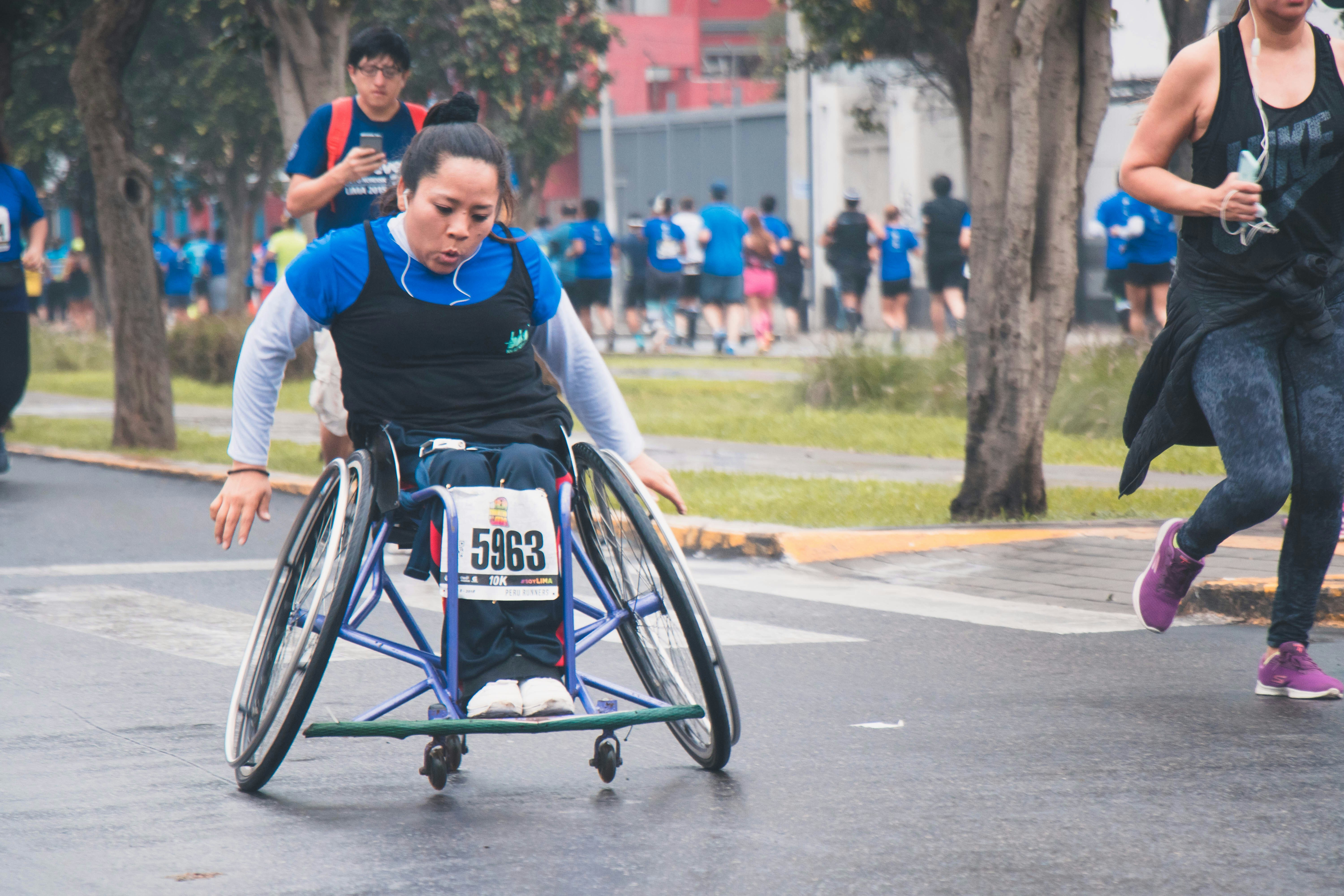 A women on the streets spinning her wheelchair.