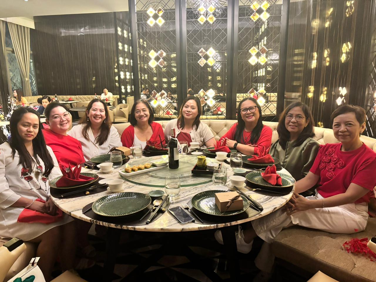 Photo of a group of SparksWealth colleagues posing together at a celebration dinner