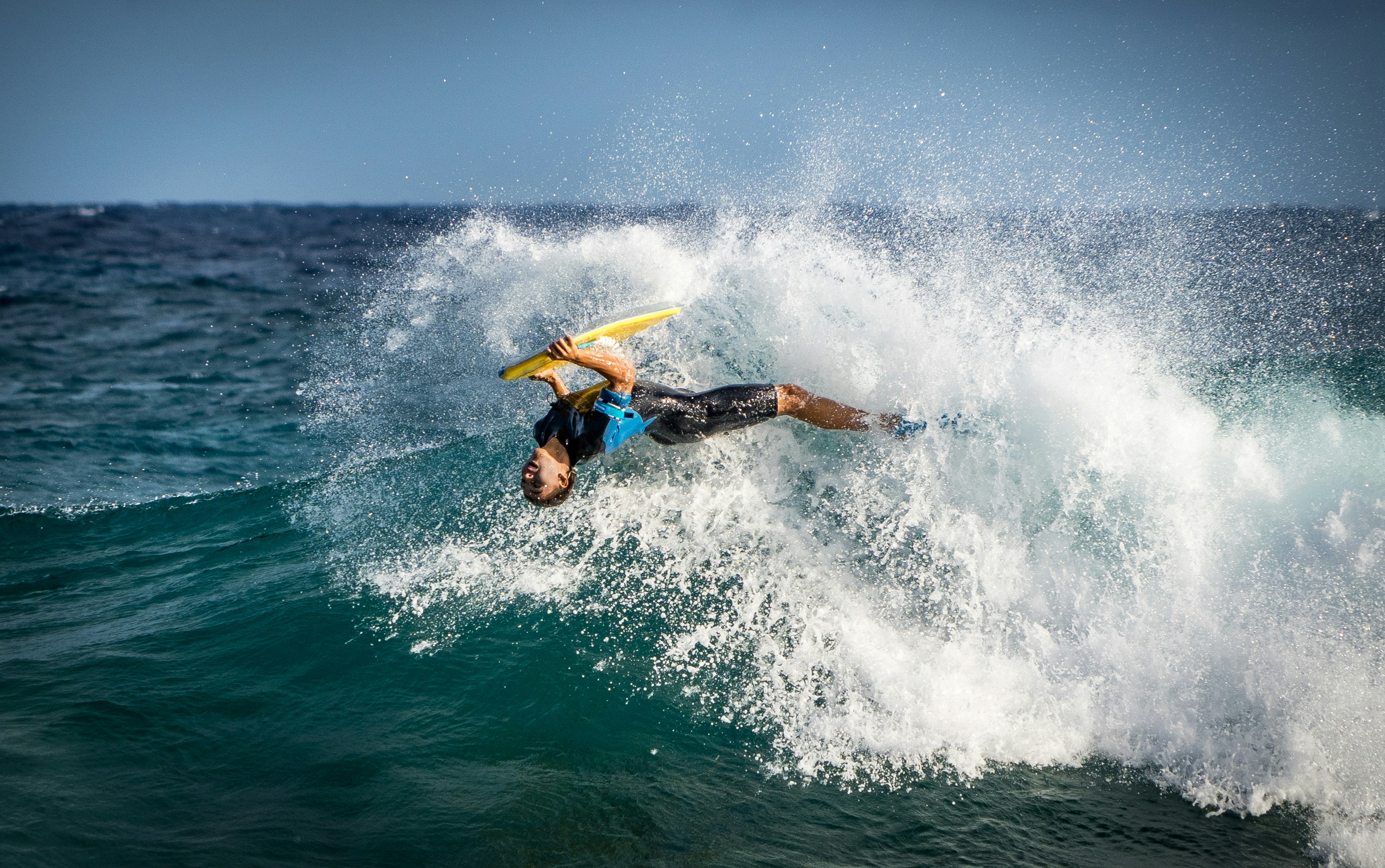 a man riding a wave on top of a surfboard