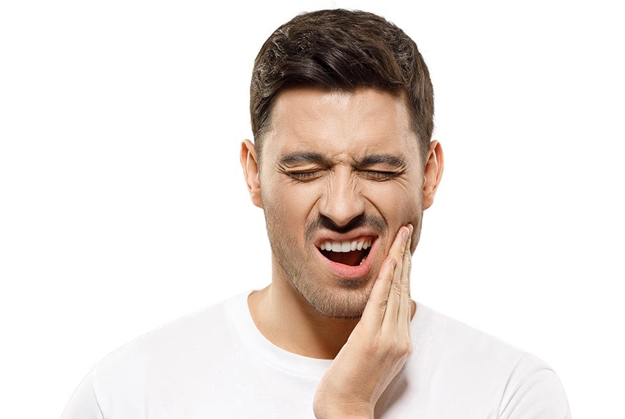 Man holding his cheek with eyes closed, expressing discomfort from jaw pain.