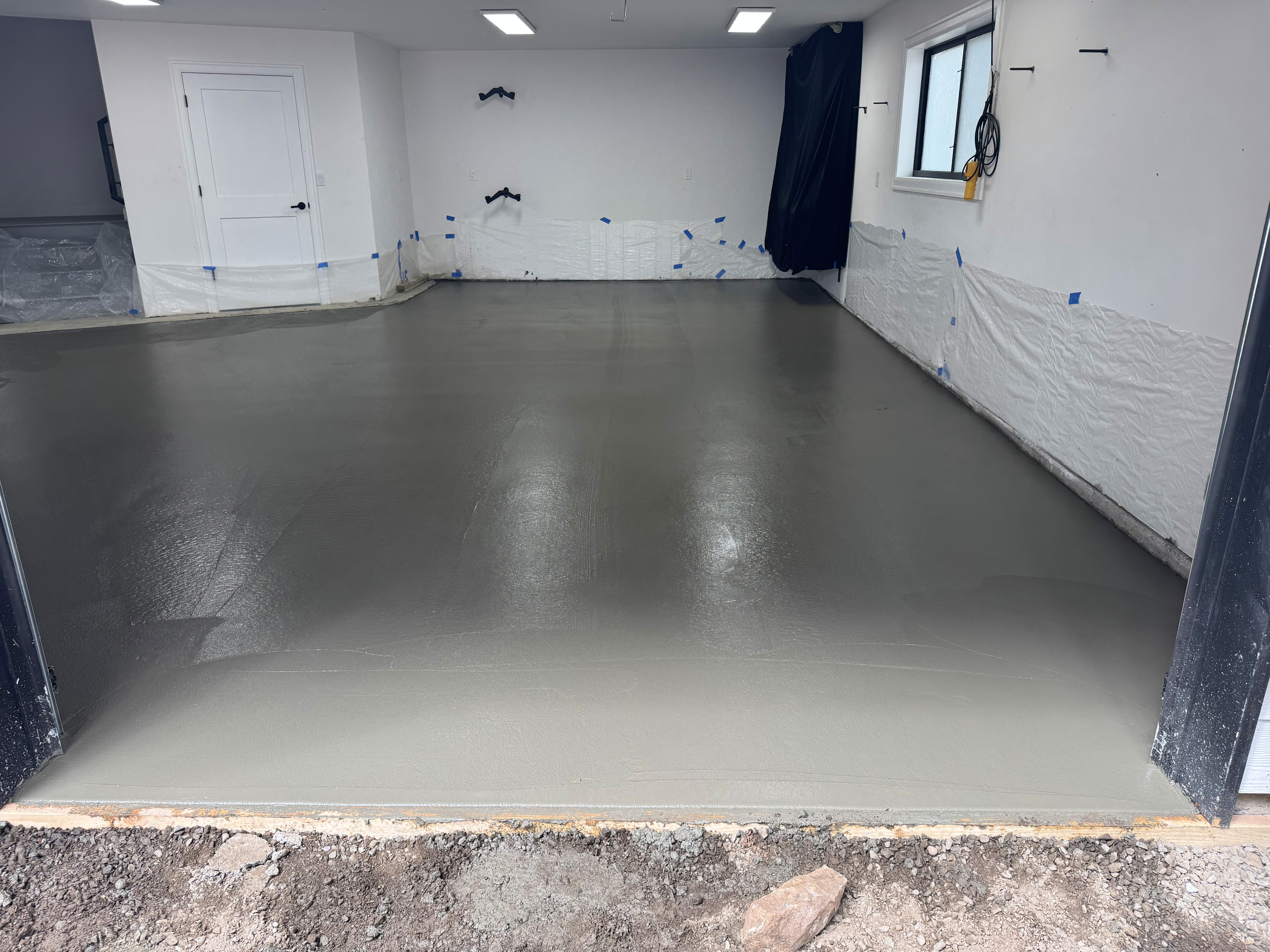 Modern living room with vertical garden, yellow sofas, and stylish coffee tables.