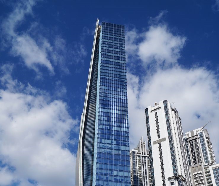 Low angle shot of Vision Tower reflecting the blue sky, representing growth and real estate success.