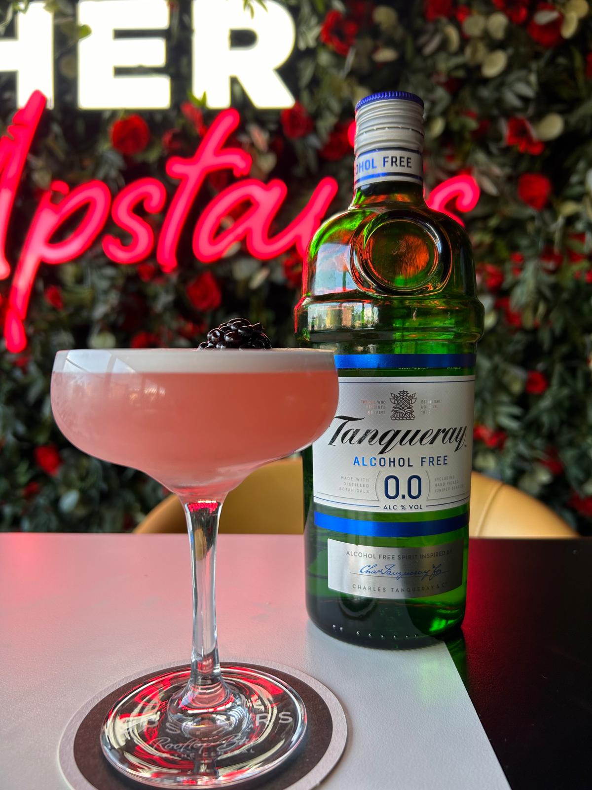 Blackberry Gin Sour 0.0% cocktail with bottle of tanqueray 0.0% at Her Upstairs