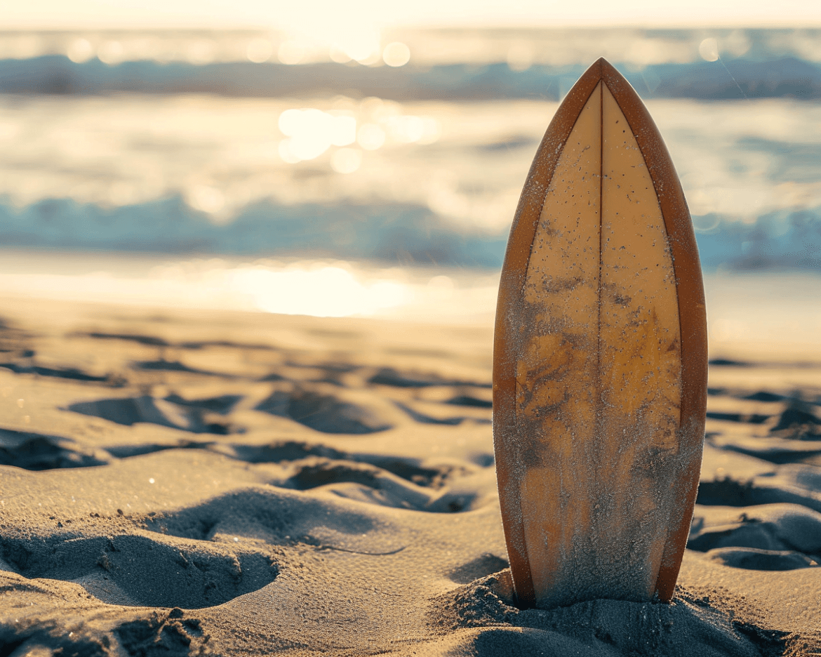 A surfboard stands upright in the sand on a beach, with the ocean waves gently rolling in and the sun setting in the background, casting a warm, golden glow over the scene.